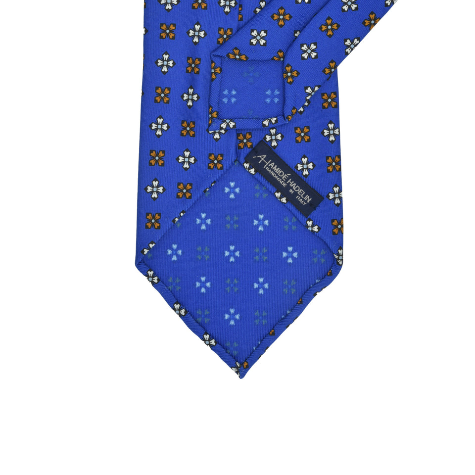 Amidé Hadelin | Wide handprinted silk medallion tie untipped, blue_back